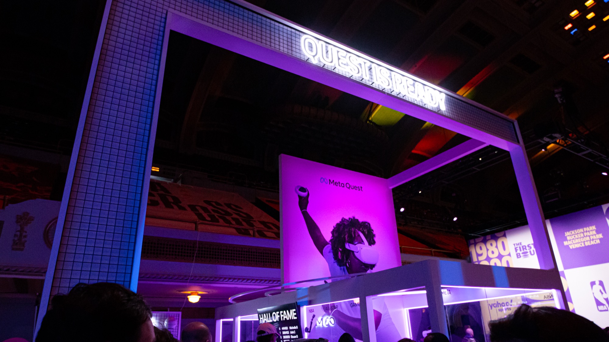 Front of the final Meta Quest booth featuring signage and a typographic graphic on the glass