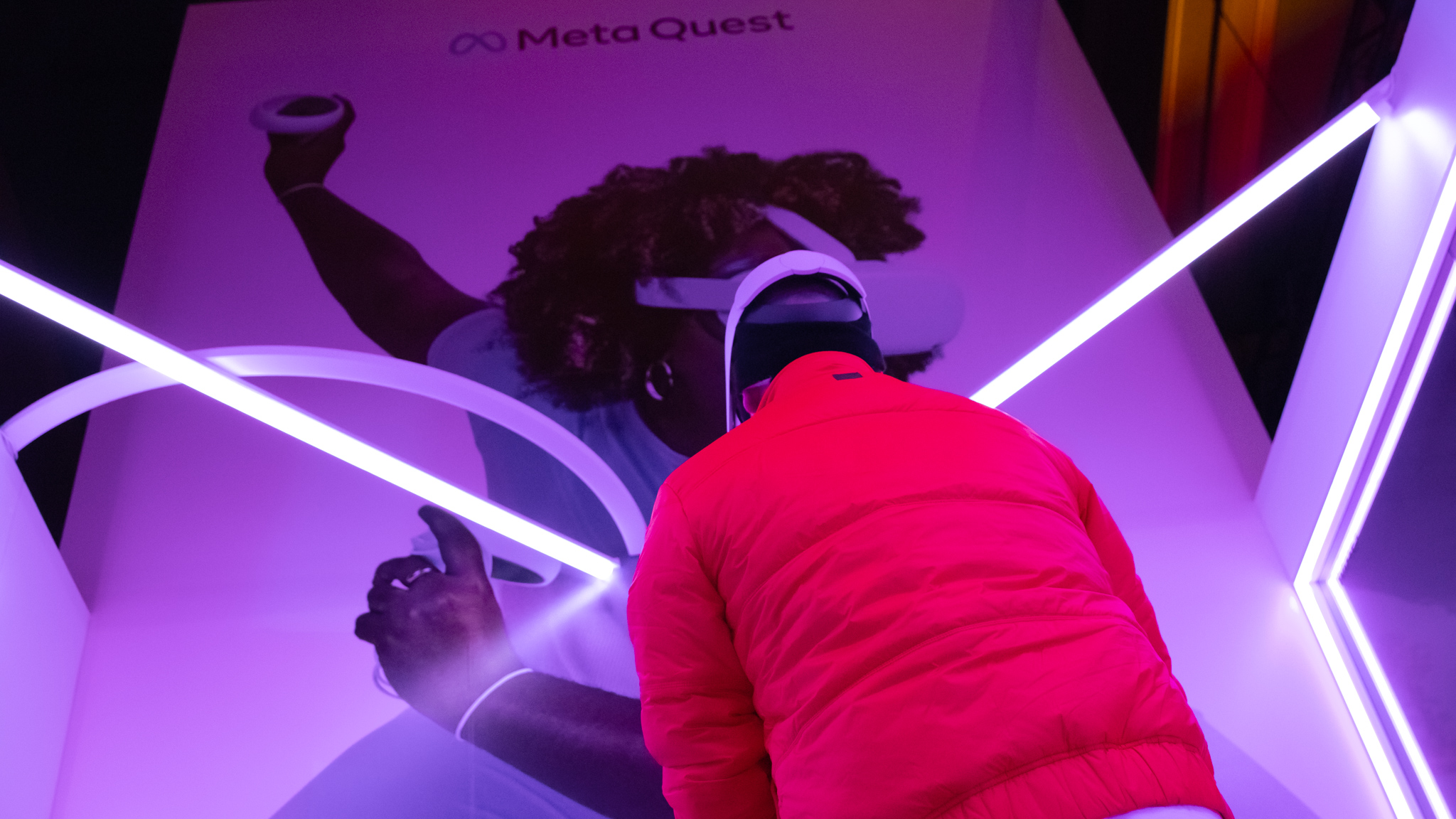 Guest playing Meta Quest in the glass booth