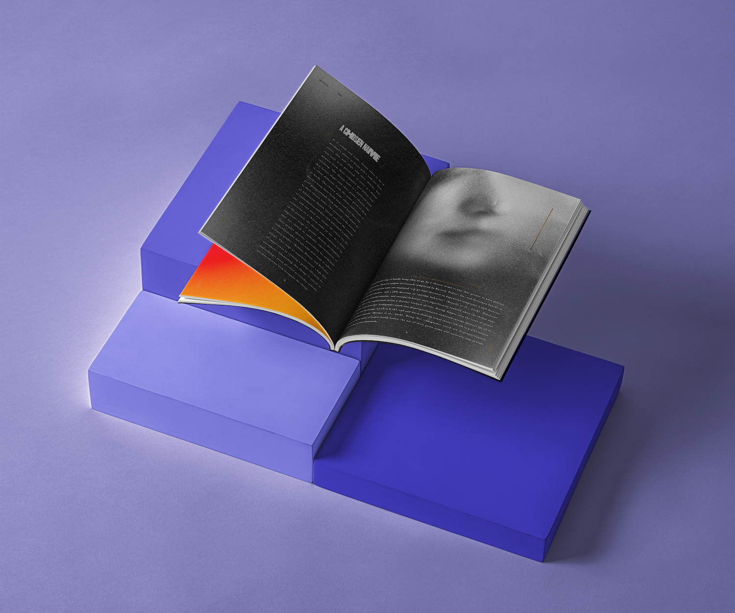 Open magazine resting on a stack of bright purple blocks against a violet backdrop, showing a black left page with dense body text and a right page with a soft black-and-white close-up of a face